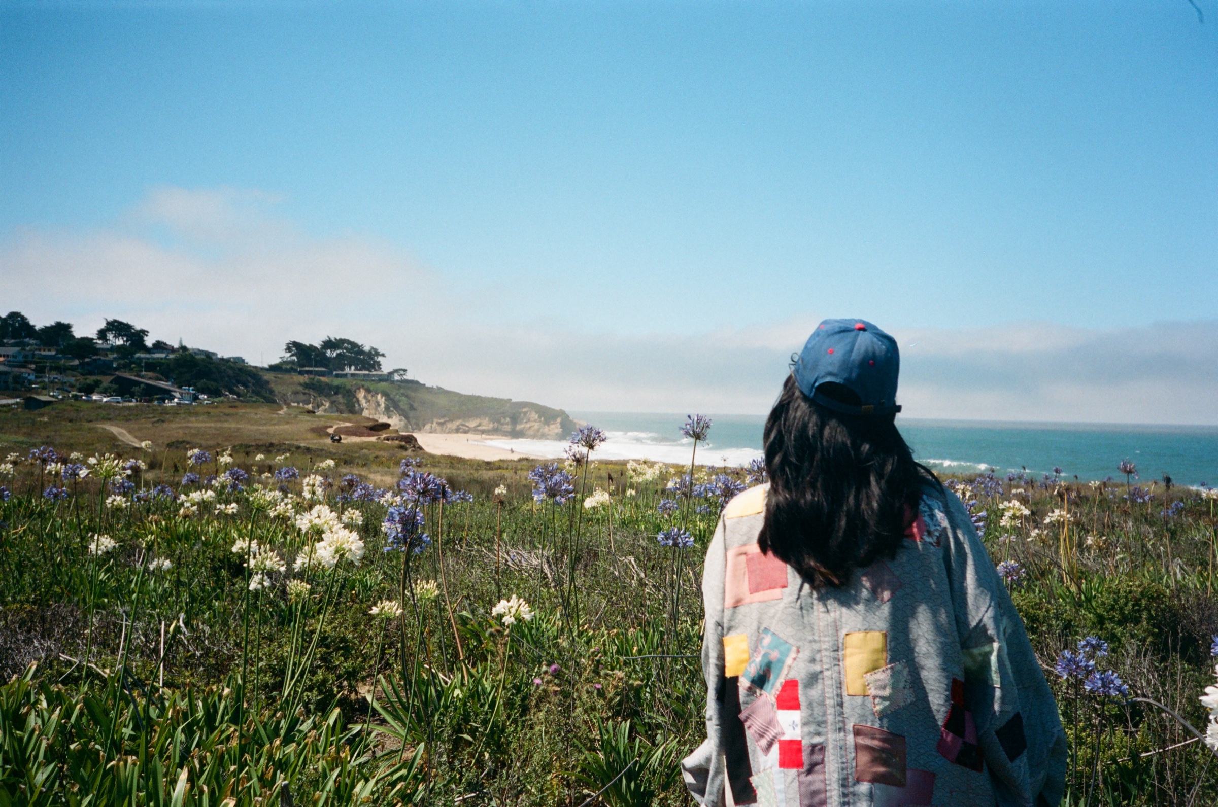 Isaboko founder Izzy Li Kostrzewa shot wearing a patchwork jacket