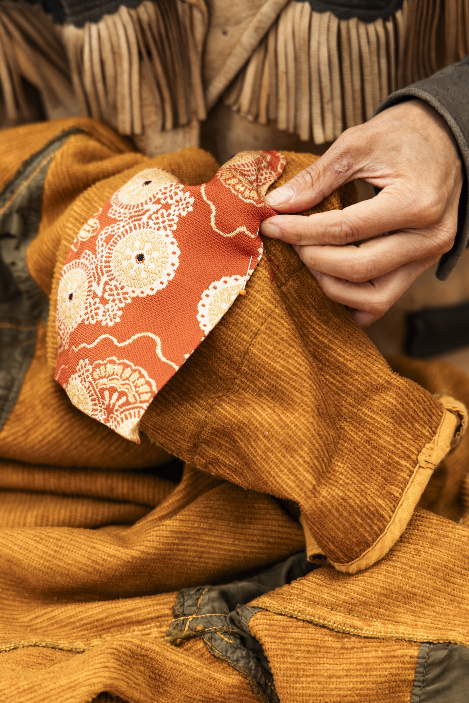 Sewing an Isaboko patch onto a garment